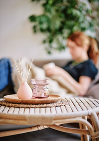 Decorative items on a table with a blurred background of a person sitting.